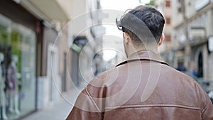 Young arab man standing backwards at street