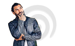 Young arab man wearing casual leather jacket thinking worried about a question, concerned and nervous with hand on chin