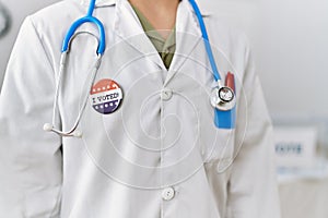 Young arab man wearing doctor uniform with bagde at electoral college