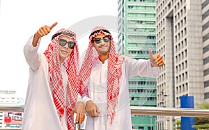 Young Arab Middle Eastern businessman team showing thumbs up as a sign of success business