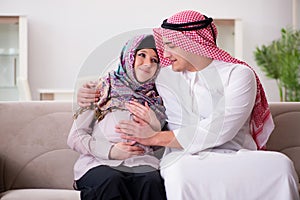 The young arab muslim family with pregnant wife expecting baby