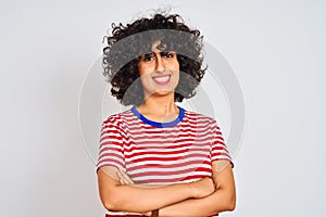 Young arab woman with curly hair wearing striped t-shirt over isolated white background happy face smiling with crossed arms