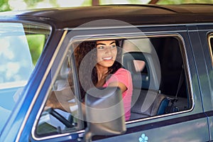 Young Arab woman driving an old van in nature