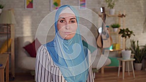 Young arab woman in a hijab with a burn scar on her face