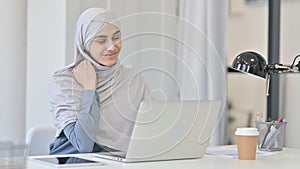Young Arab Woman with Laptop having Neck Pain