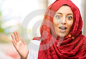 Young arabian woman wearing hijab isolated over natural background