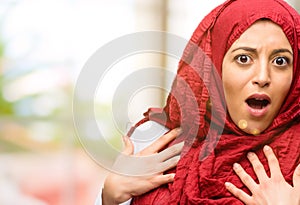 Young arabian woman wearing hijab isolated over natural background