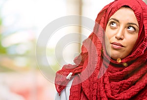 Young arabian woman wearing hijab isolated over natural background