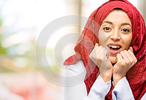 Young arabian woman wearing hijab over natural background