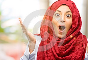 Young arabian woman wearing hijab over natural background