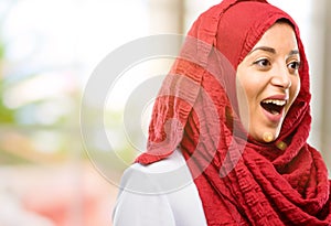 Young arabian woman wearing hijab over natural background