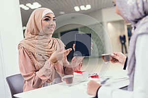 Young Arabian Women Sitting in Cafe in Modern Mall