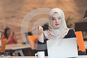 Young Arabic business woman wearing hijab,working in her startup office.