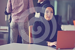 Young Arabic business woman wearing hijab,working in her startup office. Diversity, multiracial concept