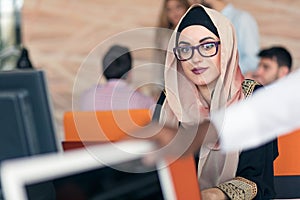 Young Arabic business woman wearing hijab,working in her startup office. photo