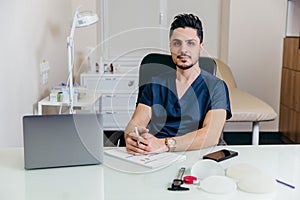 A young arabic or turkish doctor in a blue uniform conducts online counseling