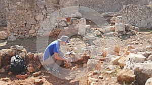 Young archeologist works on an archaeological site