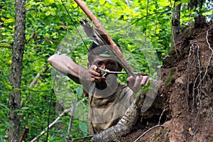 Young archer in forest