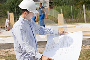 Young architect checking a structural drawing