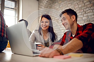 Young architect couple working late at computer