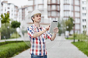 Young architect in front of apartment building