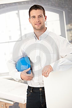 Young architect smiling in office