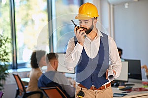 Young architect using walkie talkie