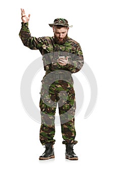 Young army soldier wearing camouflage uniform isolated on white