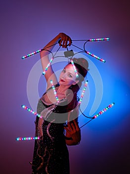 Young artist with bright makeup while light show