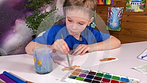 Young artist creative watercolor painting in indoor setting