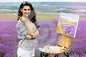 Young artist painting in lavender field