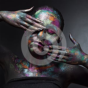 Young artistic woman in black paint and colourful powder. Glowing dark makeup. Creative body art on the theme of space