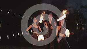 Young artists performing magic of fireshow at dusk