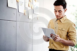 Young Asain Businessman Working on Digital Tablet in Office Meeting Room