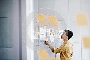 Young Asain Businessman Working in Office Meeting Room. Concentrate on Document Note at the Wall