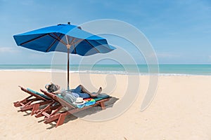 Young Asain man traveler lying on beach bench