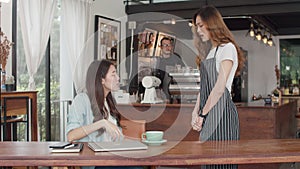 Young Asia freelance lady client talk dispute with millennial waitress feel dissatisfied with cafe bad service, mad disappointed