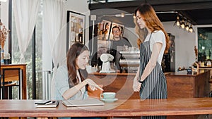 Young Asia freelance lady client talk dispute with millennial waitress feel dissatisfied with cafe bad service, mad disappointed