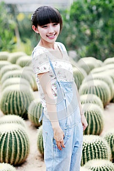 Young Asia girl in cactus field.