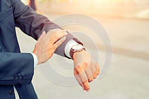 Young Asia handsome businessman looking at his watch