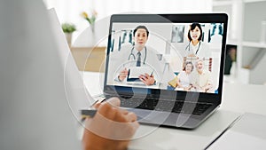 Young Asia lady doctor in white medical uniform with stethoscope using computer laptop talking video conference call with patient