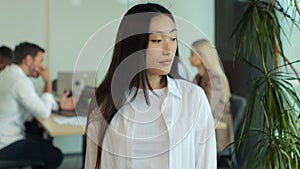 Young Asia lady standing in contemporary meeting room. Portrait of successful beautiful executive asian businesswoman