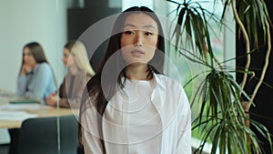 Young Asia lady standing in contemporary meeting room. Portrait of successful beautiful executive asian businesswoman