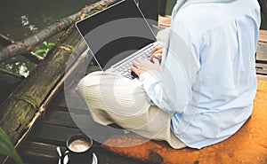 Young asia muslim woman work out office chill on green nature pa