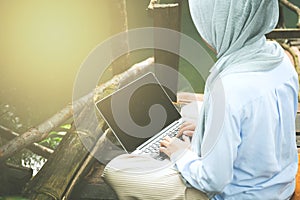 Young asia muslim woman work out office chill on green nature pa