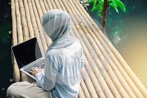 Young asia muslim woman work out office chill on green nature park concept for female entrepreneur job on chic workplace,