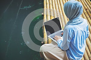 Young asia muslim woman work out office chill on green nature park concept for female entrepreneur job on chic workplace,