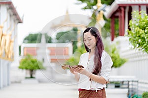 young asia woman holding Sanskrit ancient Tripitaka book