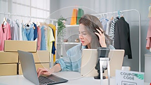 Young Asia woman workin online e-commerce shopping at home. Startup online fashion cloth business. Feeling upset and angry on the