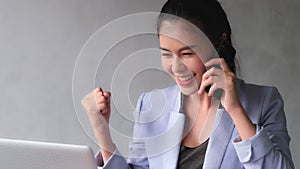 Young Asia women pick up phone and talk with customer on the progress of work